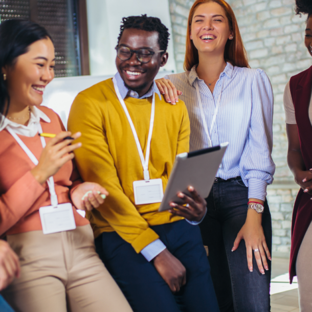 A warm, diverse group learning together at a workshop, an example of a learning community